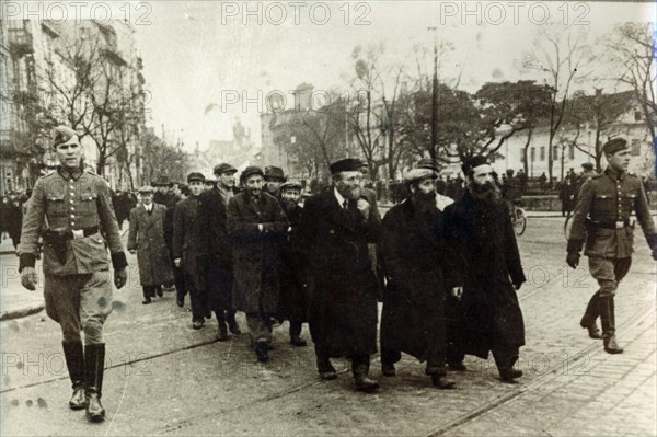 Polish Jews being escorted by German soldiers and Gestapo, Poland, March 1940. Artist: Unknown