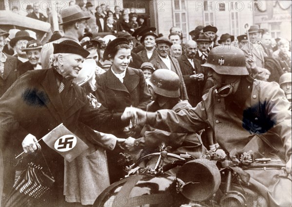 German troops are greeted by a crowed in Luknov, Czech Republic, c1939. Artist: Unknown