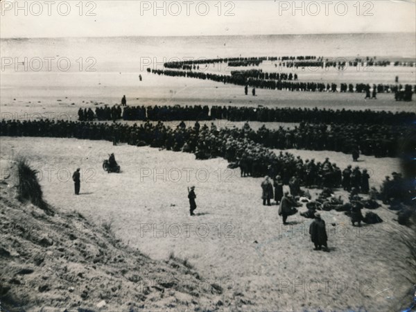 British and French troops wait on the dunes to be evacuated, Dunkirk, 1940. Artist: Unknown