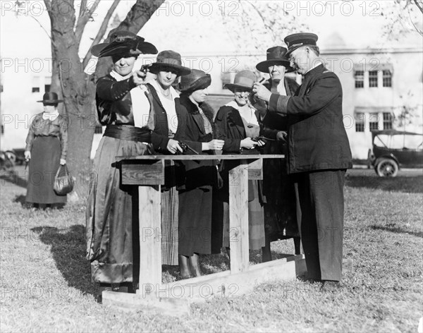 Police officer teaching women how to shoot, c. 1920.