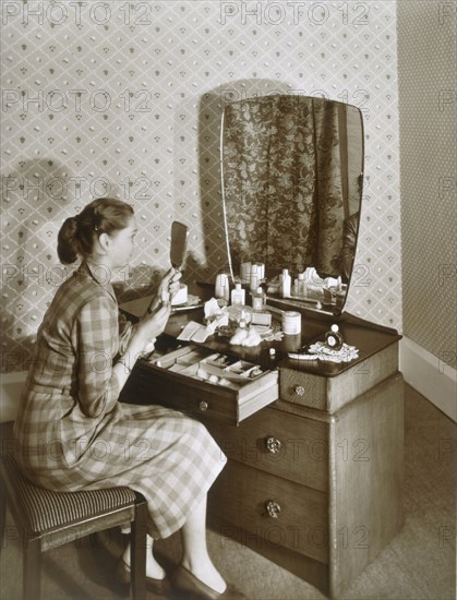 Woman at her dressing table, c1955. Creator: English Photographer (20th Century).