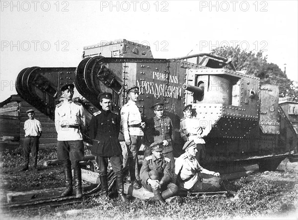 Soldiers of the Volunteer Army before the tank 'General Drozdovsky, 1919.  Artist: Anon