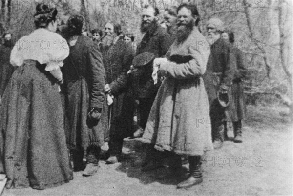 Landowner giving the Paschal greeting to her peasants, Russia, 1890s. Artist: Unknown