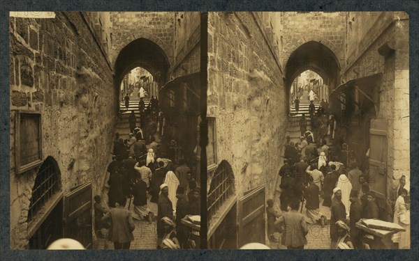 Via Dolorosa, Jerusalem. Pilgrims at station of the Cross (Stereograph), 1913.