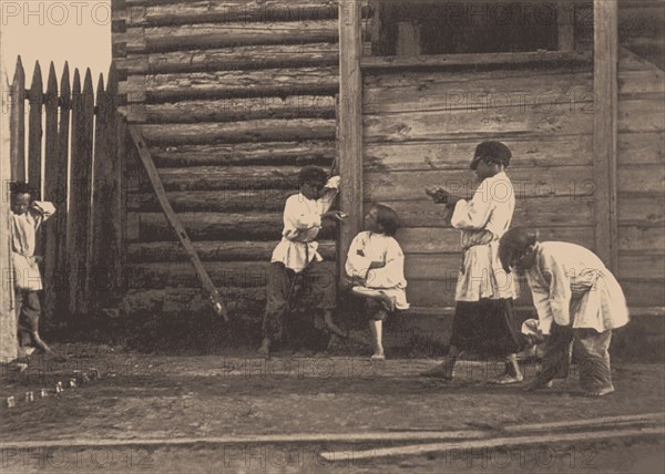 Boys playing Knucklebones, 1860s.