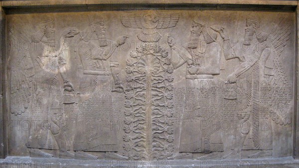 Relief with two figures of Ashurnasirpal, winged mythological beings and the god Ashur, before the Tree of Life, 885-860 BC. Artist: Assyrian Art