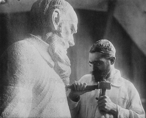 Russian sculptor Sergey Merkurov (1881-1952) working on his statue of Leo Tolstoy Artist: Anonymous