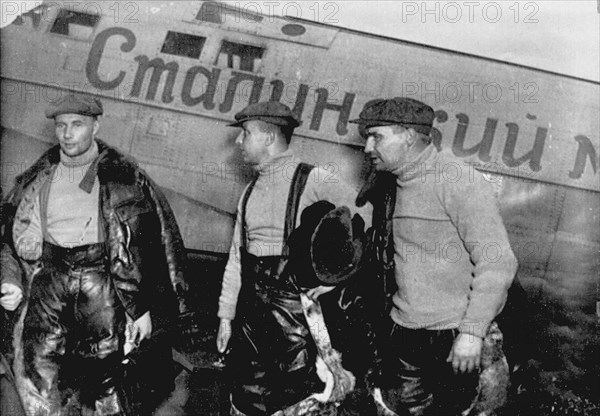 Alexander Belyakov, Georgiy Baidukov and Valery Chkalov by their plane on June 20, 1937. Artist: Anonymous