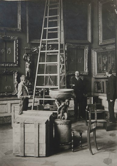 Preparing paintings for evacuation from one of the Italian halls at the Hermitage, 1917.