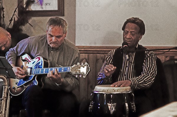 Frank Holder, Guyanan jazz singer and percussionist with Shane Hill, The Castle, Outwood, Surrey.    Artist: Brian O'Connor