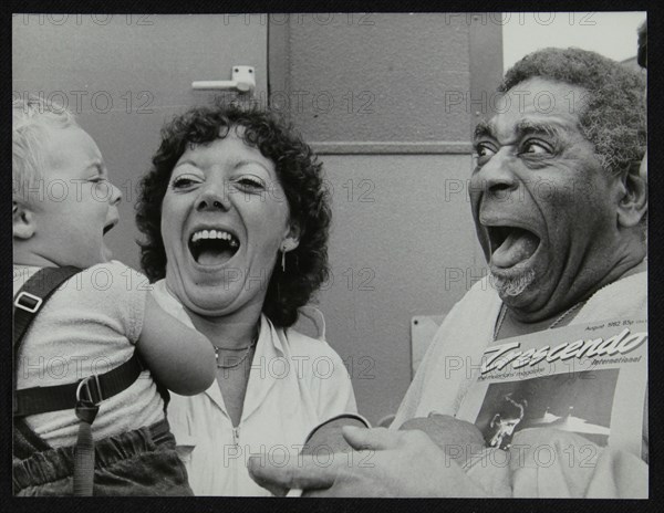 Dizzy Gillespie meeting baby Gary Colfer at Knebworth, Hertfordshire, July 1982. Artist: Denis Williams