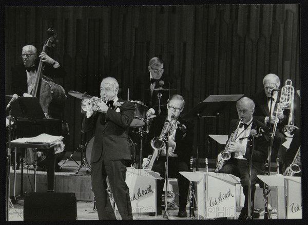 The Ted Heath Orchestra in concert, London 1985. Pictured are Lennie Bush (double bass), Kenny Baker Artist: Denis Williams