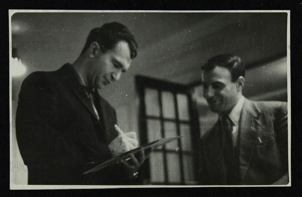 Dave Brubeck signing an autograph, c1950s. Artist: Denis Williams