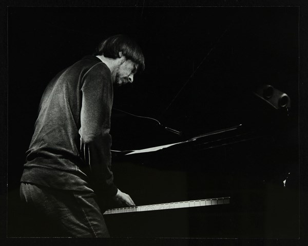 Michael Garrick on the piano at The Stables, Wavendon, Buckinghamshire. Artist: Denis Williams