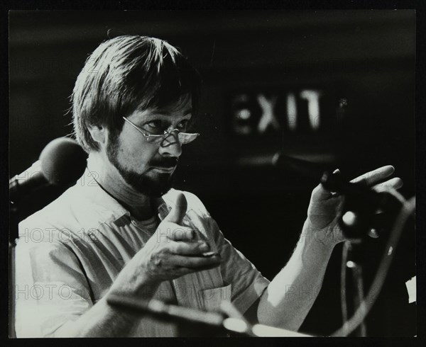 Michael Garrick conducting an orchestra at Berkhamsted Civic Centre, 1985. Artist: Denis Williams