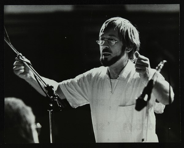 Michael Garrick conducting an orchestra at Berkhamsted Civic Centre, 1985. Artist: Denis Williams