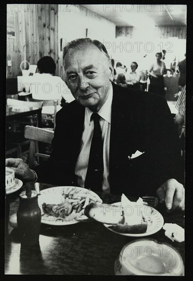 Drummer Max Abrams enjoying a plate of fish and chips in a Soho chip shop, London, 1983. Artist: Denis Williams