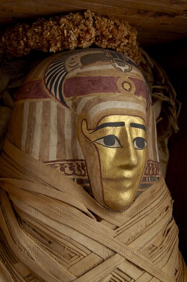 Ptolemaic coffin, mummy with gilt mask and floral garlands, Roman Period (Egypt), c30BC-AD641. Artist: Unknown.