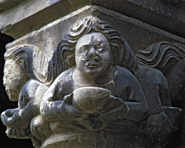 Capital of one of the Gothic galleries of the cloister built between 1387-1401. Female figure wit?