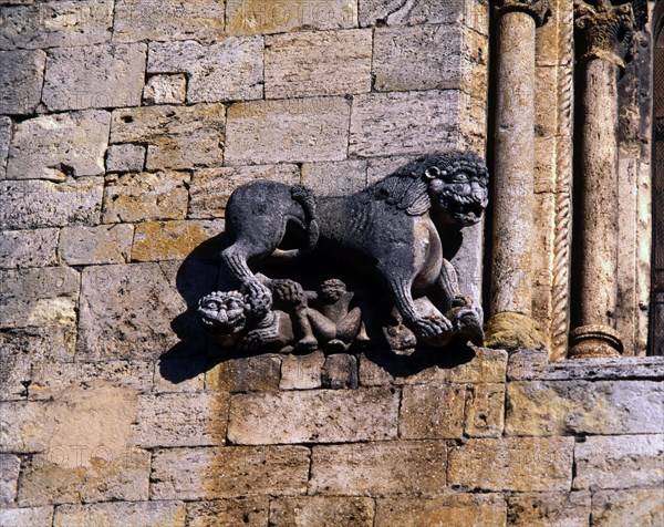 Church of San Pedro de Besalu, lion protecting a human figure and decorating the front window of ?