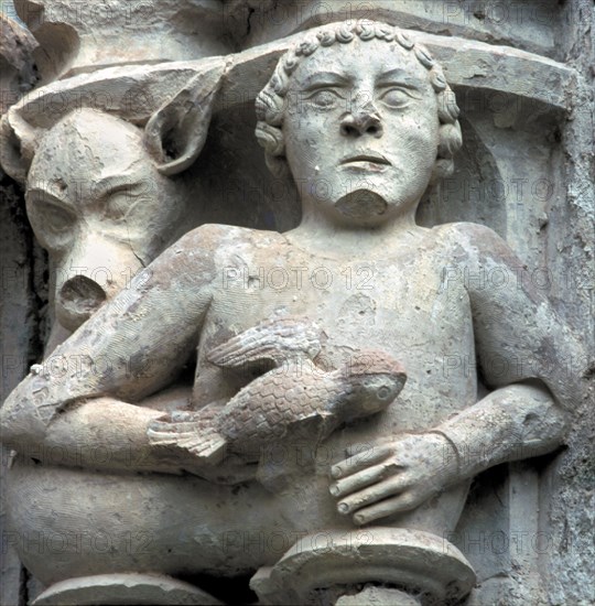 Detail of a capital showing a man with a pigeon in the hand, in the cloister of the Monastery of ?