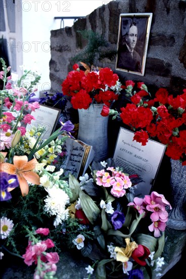 Flower-filled tomb in the cemetery of Cotlliure with the picture of Antonio Machado (1875-1939), ?