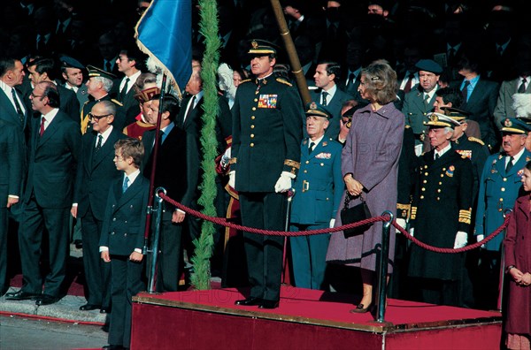 Juan Carlos I, King of Spain, with Queen Sofia and Prince Felipe, presiding over a military parad?