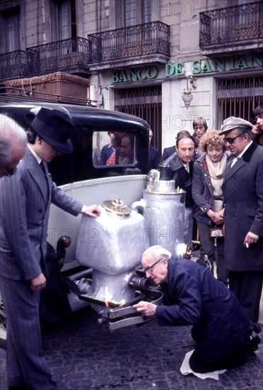 Participants in the rally Barcelona Sitges, period dressed in a car with wood gas generator.