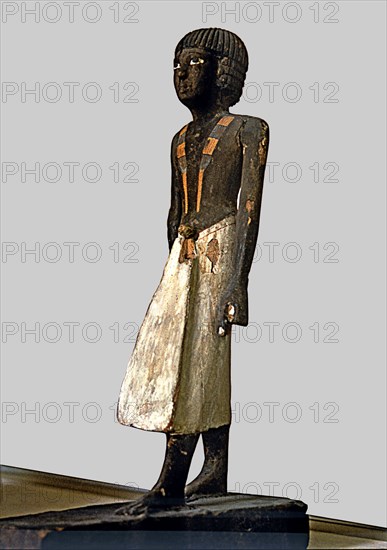 Figurine of a man for a tomb, made of polychromed wood, side view.