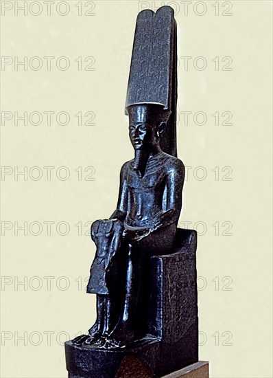 Statue of the god Amon protecting Tutankhamen, made in black granite, 1350 b.C., partially destro?