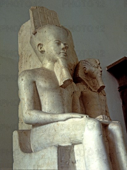 Amon seated next to Tutankhamun, statue made in calcite, 1350 BC.