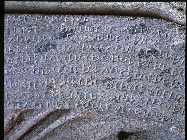 Etruscan writing in a stone sarcophagus with reliefs of Eastern influence.