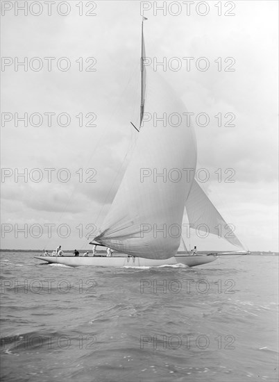 'Istria' sailing downwind under spinnaker, 1912.  Creator: Kirk & Sons of Cowes.