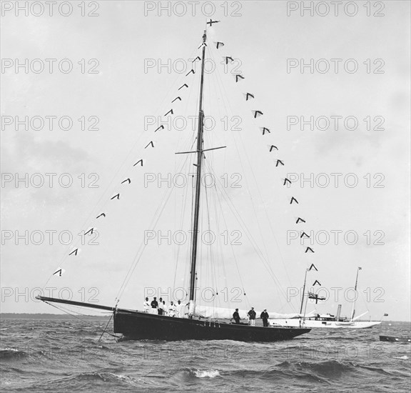 'Bloodhound' at anchor with prize flags, 1909. Creator: Kirk & Sons of Cowes.