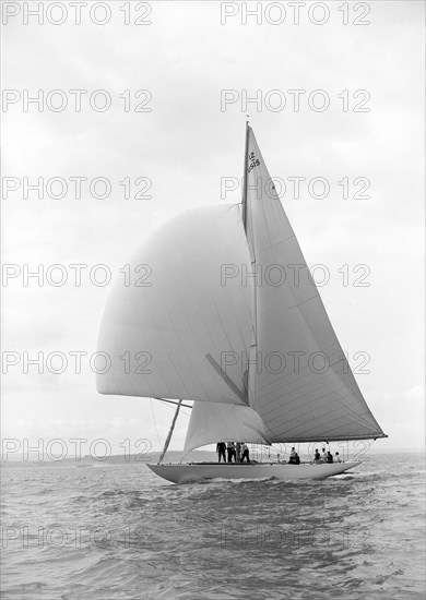 The US built 12 Metre class 'Vim' sailng with spinnaker, 1939.  Creator: Kirk & Sons of Cowes.