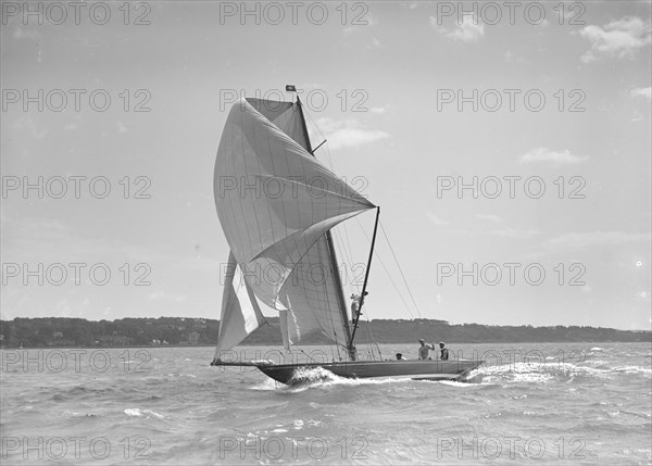 The 8 Metre sailing yacht 'Endrick' sailing downwind under spinnaker, 1911. Creator: Kirk & Sons of Cowes.