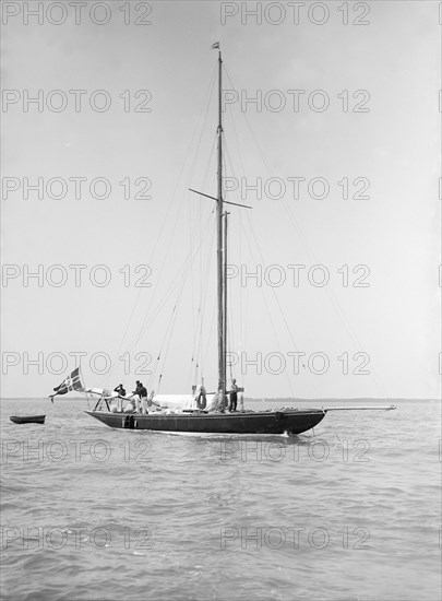 The sailing yacht 'Rollo' at anchor, 1911. Creator: Kirk & Sons of Cowes.