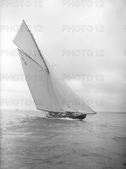 The 12 Metre sailing yacht 'Rollo' racing upwind, 1911. Creator: Kirk & Sons of Cowes.