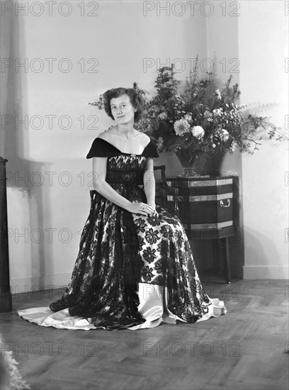 Portrait of seated woman in evening dress, (Isle of Wight?), c1935.  Creator: Kirk & Sons of Cowes.