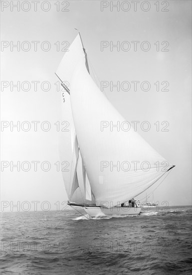 The 19-metre class 'Corona' running downwind, 1911. Creator: Kirk & Sons of Cowes.