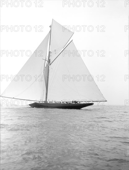 The 221 ton gaff-rigged cutter 'Britannia' sailing under spinnaker, 1913. Creator: Kirk & Sons of Cowes.