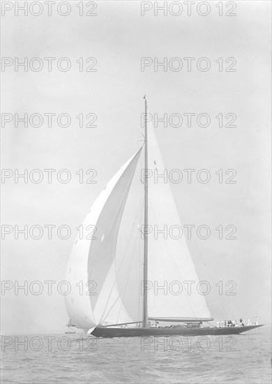 'Britannia' sails downwind under spinnaker, 1935. Creator: Kirk & Sons of Cowes.