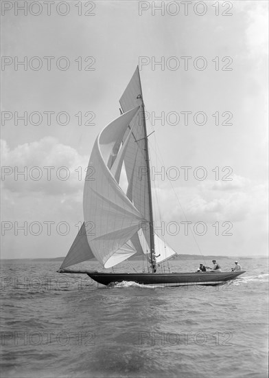 The 8 Metre 'Endrick' sailing downwind under spinnaker, 1911. Creator: Kirk & Sons of Cowes.