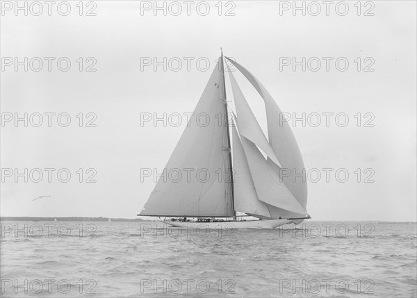 The 23-metre cutter 'Astra' sailing with spinnaker.  Creator: Kirk & Sons of Cowes.
