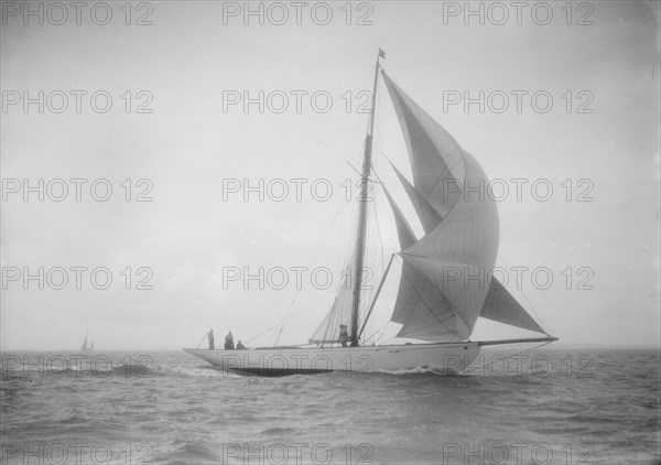 The cutter 'Westwind' sailing with spinnaker, 1912. Creator: Kirk & Sons of Cowes.