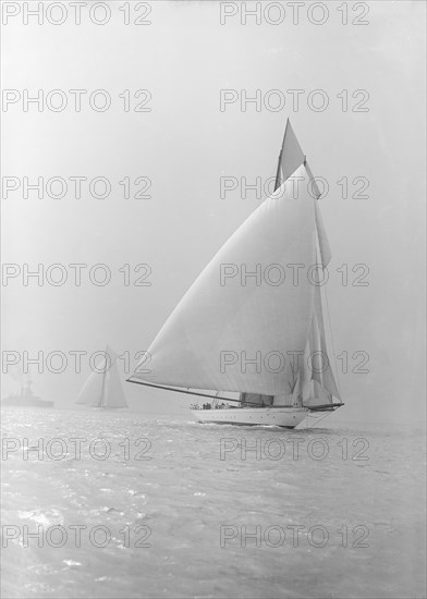 The 250 ton schooner 'Germania' running under spinnaker, 1913. Creator: Kirk & Sons of Cowes.