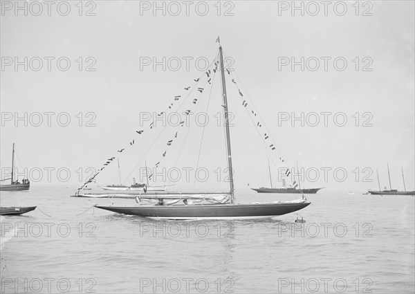 The 6 Metre 'Cremona' moored with flags, 1913. Creator: Kirk & Sons of Cowes.