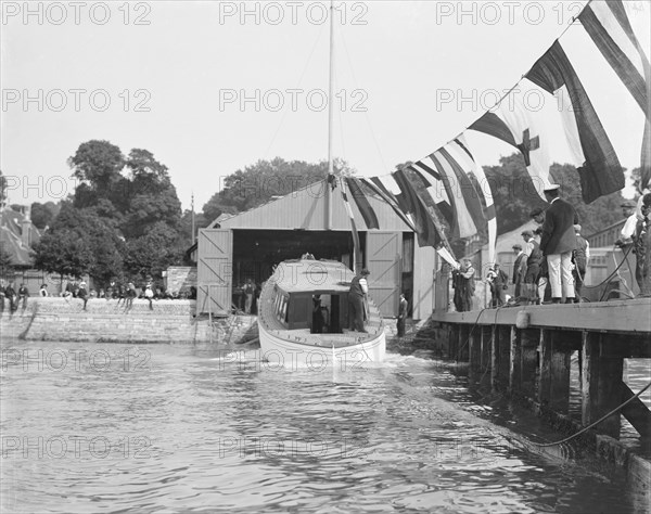 Saunders' motor launch being launched, 1908. Creator: Kirk & Sons of Cowes.