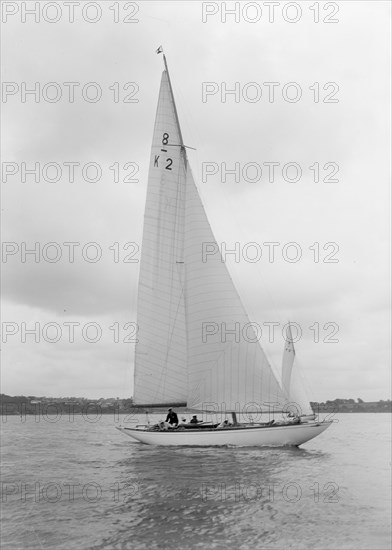 The 8 Metre Carron (K2) sailing upwind, 1934. Creator: Kirk & Sons of Cowes.