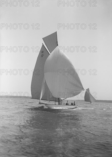 The 8 Metre 'Ierne' running down wind under spinnaker, 1913. Creator: Kirk & Sons of Cowes.